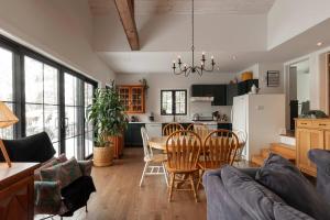 a kitchen and living room with a table and chairs at Waterfront & Nature - Chalet Lac Clair in Entrelacs +35 photos