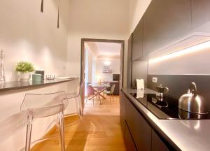 a kitchen with a counter and a dining room at Amazing San Lorenzo 19 Apt with Private Parking in Genoa