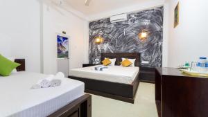 a hotel room with two beds and a bathroom at Pearl Guest House in Dambulla