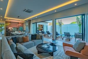 a living room with a couch and a table at Dara Villas - Rawai in Rawai Beach