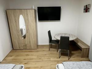 a room with a table and a tv on a wall at Apartment in Bergkamen in Bergkamen