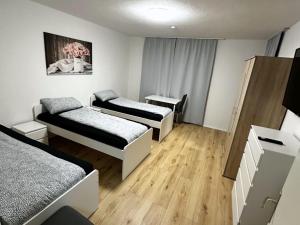 a room with three beds and a table with a picture at Apartment in Bergkamen in Bergkamen