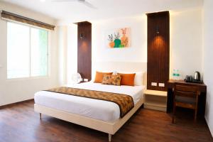 a bedroom with a bed and a desk and a window at Mandola Stays in Girgaon +10 photos