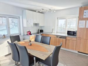 a kitchen with a wooden table and chairs in a room at Kreischberg Superior with Sauna in Sankt Lorenzen ob Murau