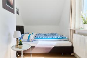 a bed in a room with a table at Ferienwohnung Trave Ufer Moba-Travel in Lübeck