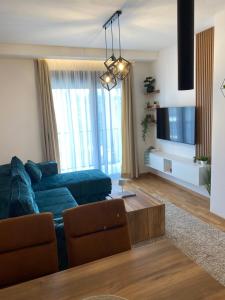 a living room with a couch and a flat screen tv at Apartman Tornik Relax&Spa 3 in Zlatibor