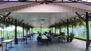 a pavilion with tables and chairs in a restaurant at Mata Ie Resort in Sabang
