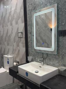a bathroom with a white sink and a mirror at Sunrise Villa in Kandy +33 photos