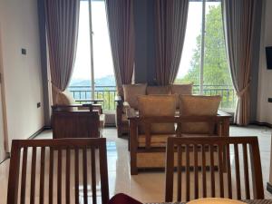 a living room with chairs and a large window at Sunrise Villa in Kandy
