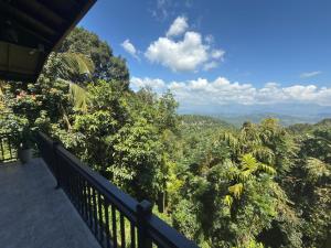 a balcony of a house with a view of the forest at Sunrise Villa in Kandy