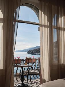 a room with a table and a view of the water at Amadria Park Hotel Milenij in Opatija +99 photos