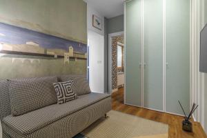 a living room with a couch and a painting on the wall at SEBASTIAN Apartamentos in Getaria
