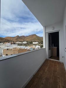 a white room with a view of the mountains at La Artesana Níjar in Níjar