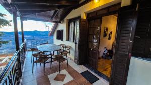 a balcony of a house with a table and chairs at Casa di Fiamengo in Ano Trikala