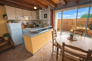 a kitchen and dining room with a table and chairs at Maison Monbazillac avec piscine 2-4 pax in Monbazillac +3 photos