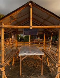 a wooden pavilion with a picnic table in it at Shigemary Kubohouse in Capepisa