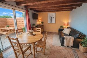 a living room with a table and a couch at Maison Monbazillac avec piscine 2-4 pax in Monbazillac