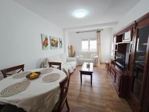 a living room with a table and a couch at La Artesana Níjar in Níjar