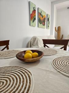 a table with a bowl of lemons on it at La Artesana Níjar in Níjar +7 photos