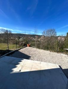 a sidewalk with a fence and a blue sky at Le Cocon de Laroque in Laroque