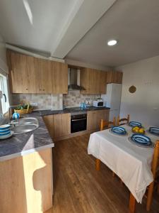 a kitchen with a table with two chairs and a sink at La Artesana Níjar in Níjar