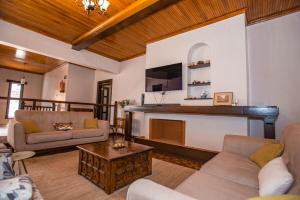 a living room with couches and a fireplace at Cozy Stead Hotel - Haven House, Gigiri in Nairobi