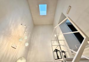 a white staircase with a mirror in a room at Residenza Garibaldi in Monopoli +58 photos