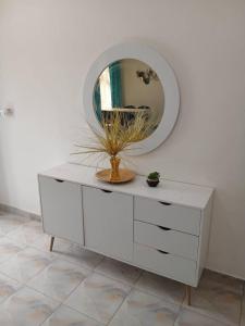 a white dresser with a mirror on top of it at Zahra Suites in Elephant Island