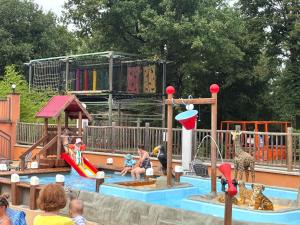 a group of children playing in a water park at Camping Domaine de Senaud in Albon