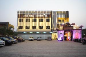 a large building with cars parked in a parking lot at Hotel Padma Residency in Datia