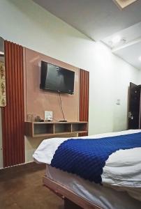 a bedroom with a bed and a flat screen tv at Hotel Padma Residency in Datia +19 photos