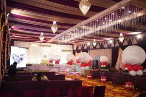 a room with purple and white balloons and a stage at Hotel Padma Residency in Datia