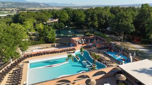 an overhead view of a swimming pool at a resort at Camping Domaine de Senaud in Albon