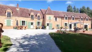 a large brick house with a yard in front of it at Le Chêne Guesthouse in Aunou-sur-Orne