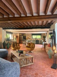 a living room with a couch and a table at Le Chêne Guesthouse in Aunou-sur-Orne