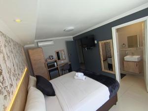 a hotel room with a bed and a couch at Bayside Hotel Empangeni in Empangeni
