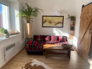 a living room with a couch and a table at Luxusný apartmán u Loly in Polomka +1 photo