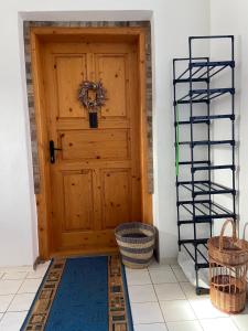 a wooden door in a room with a basket at Luxusný apartmán u Loly in Polomka