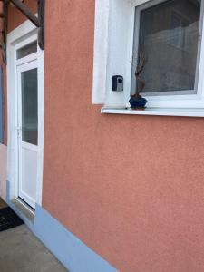 a window with a potted plant sitting on a window sill at Luxusný apartmán u Loly in Polomka