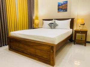 a bedroom with a large bed with two night stands at Sunrise Villa in Kandy