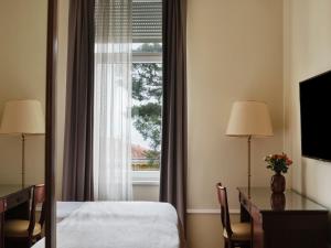a hotel room with a bed and a window at Amadria Park Hotel Agava in Opatija