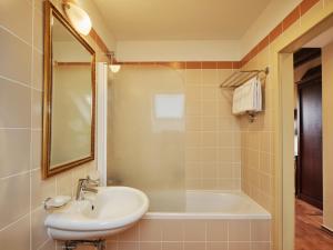 a bathroom with a sink and a tub and a mirror at Amadria Park Hotel Agava in Opatija +44 photos