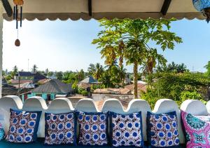 a row of blue and white pillows sitting on a table at Dhow House - Rooftop Lounge with Sunrise Views in Bagamoyo