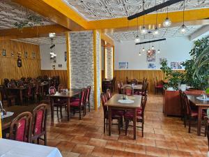 a restaurant with tables and chairs in a room at Hotel Pavla Vysočina in Nové Město na Moravě