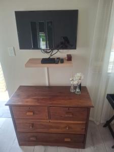 a wooden dresser in a room with a mirror at 33 On Loop, Flat 2 in Ladybrand