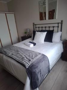 a bedroom with a large bed with a blanket on it at 33 On Loop, Flat 2 in Ladybrand