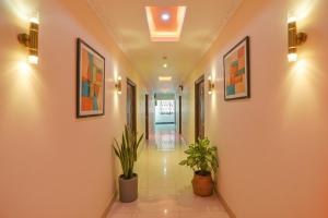 a hallway with two potted plants in a building at FabHotel Sri Balaji Grand in Hyderabad