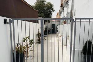 a white fence with some plants and a table at Larnaca - Studio - Sleeps 4 - Garden - Parking in Larnaca +3 photos