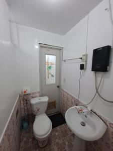 a bathroom with a toilet and a sink at Imari's Apartment in San Isidro +13 photos
