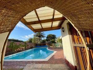 an archway over a swimming pool in a house at Serenity in Fish Hoek